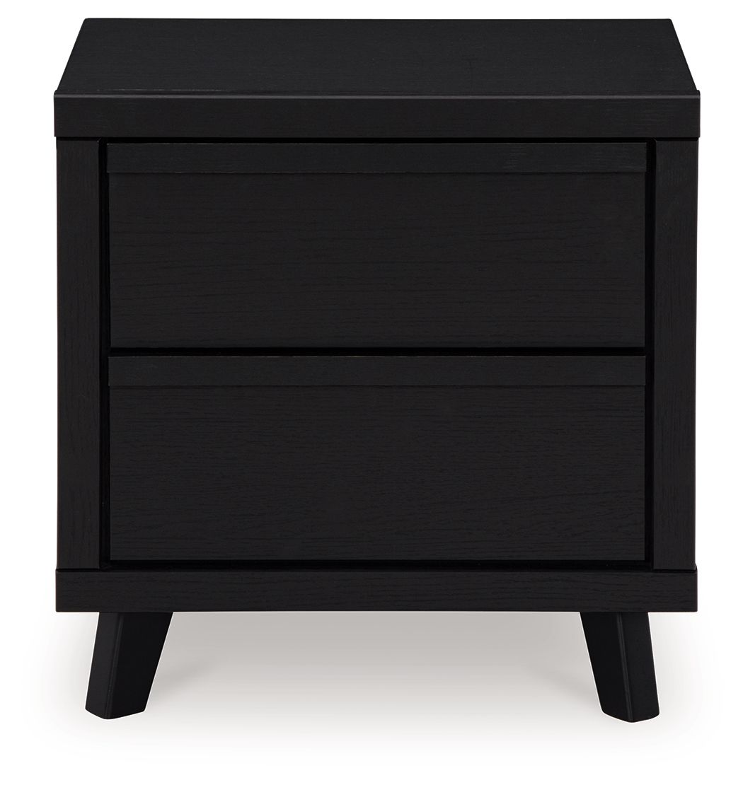 Black two-drawer night stand with two stacked drawer fronts and dark legs