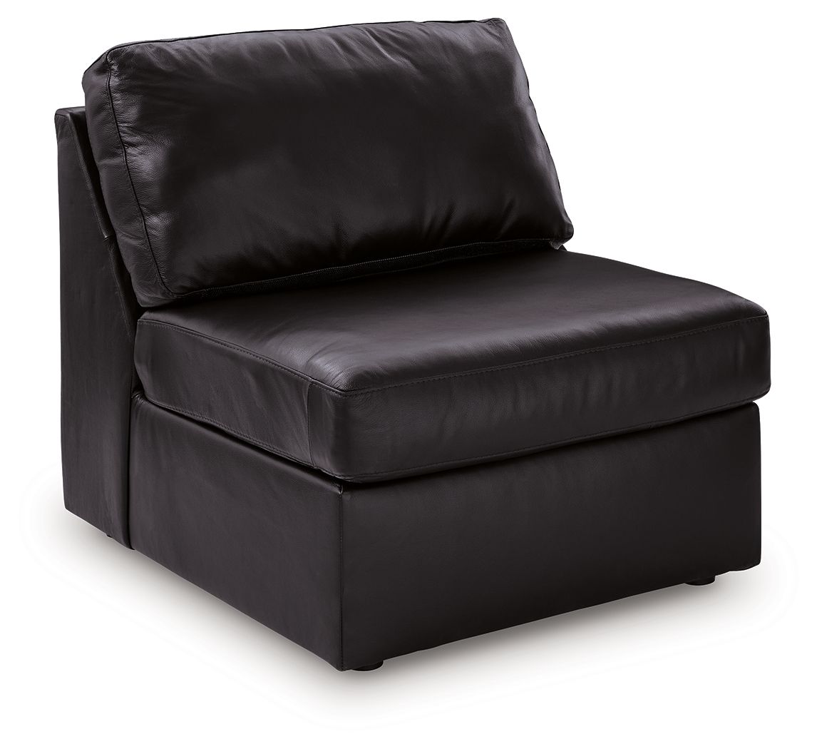 Black armless chair with padded seat and back, smooth leather-look upholstery.