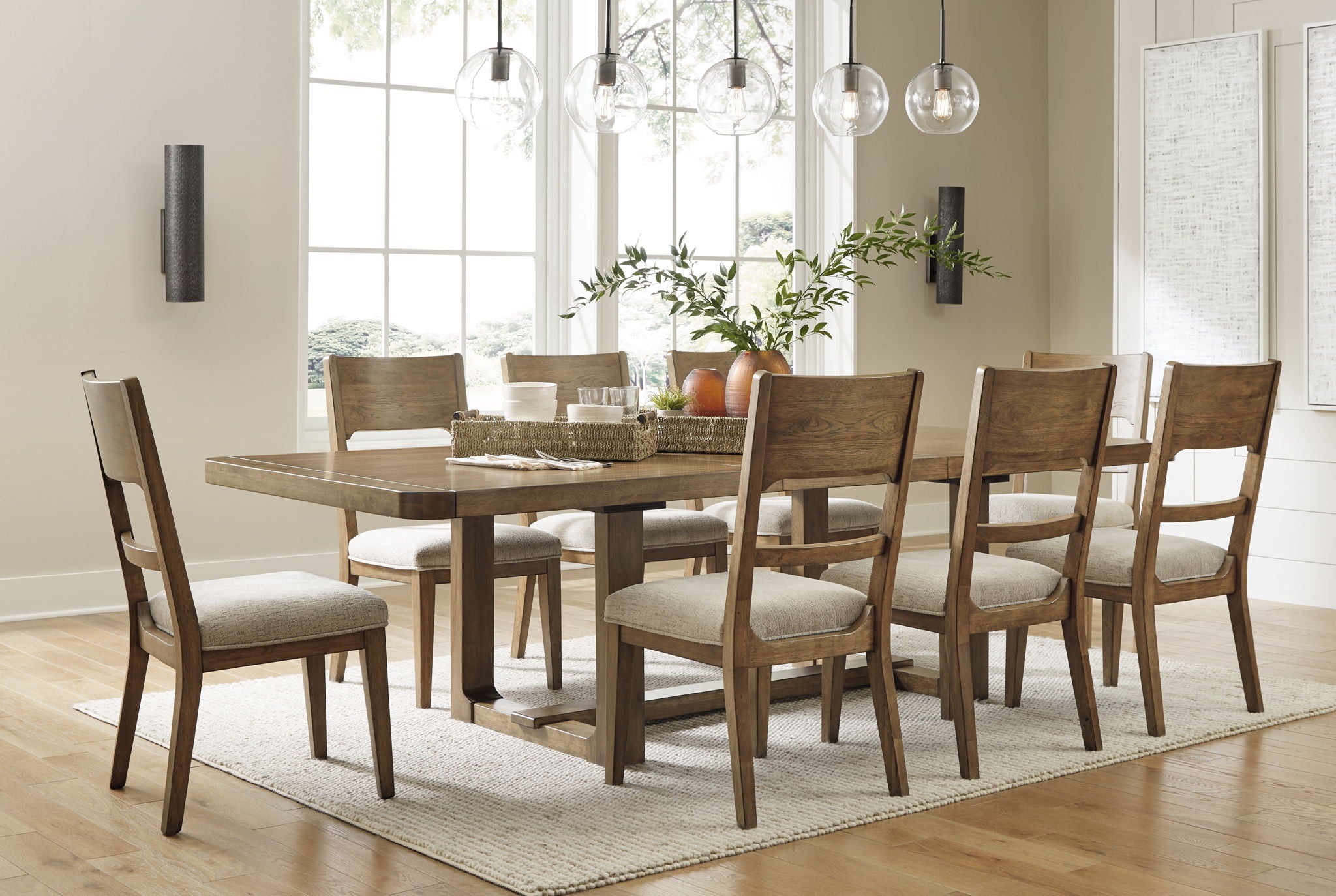 Light brown dining table with dining chairs arranged around