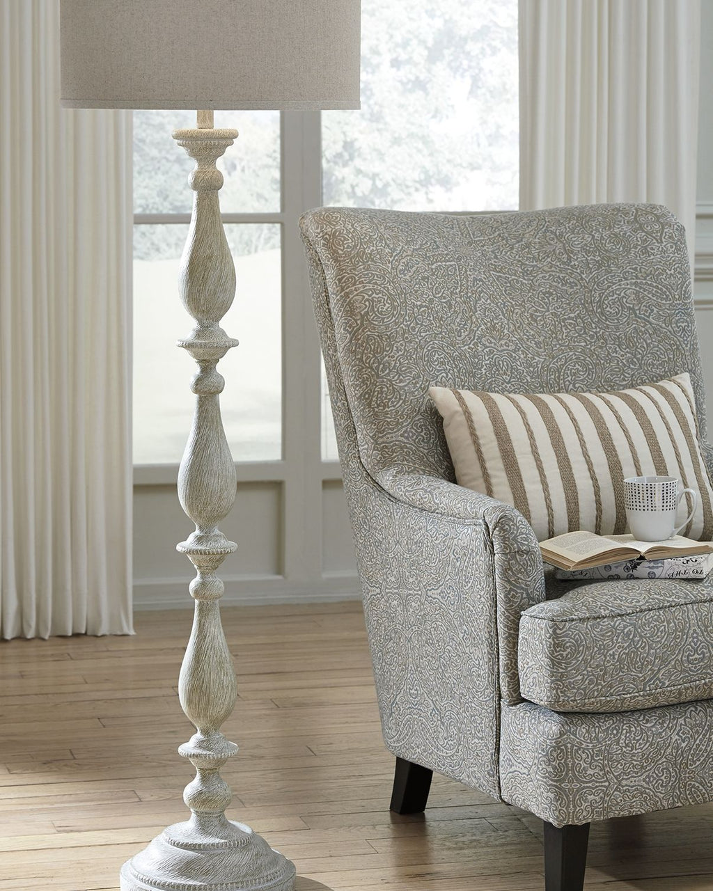 Whitewash poly floor lamp with beige fabric drum shade and turned pedestal base