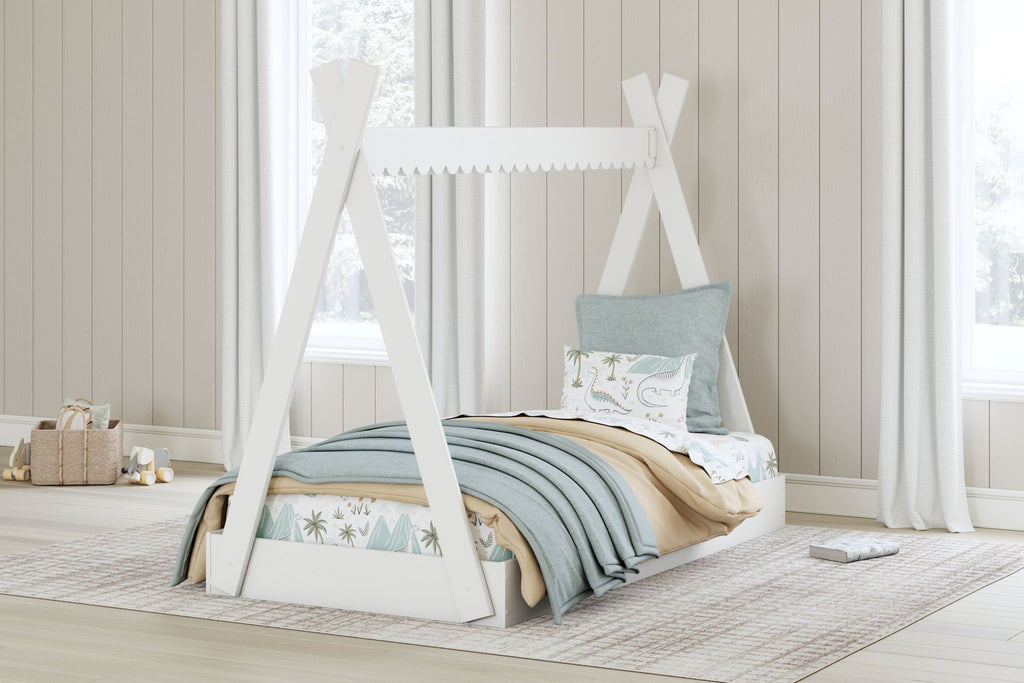 White tent bed frame in a child bedroom, with mattress and decorative pillows
