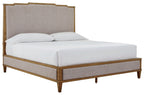 Upholstered panel bed with light gray fabric headboard, wood frame, white mattress cover