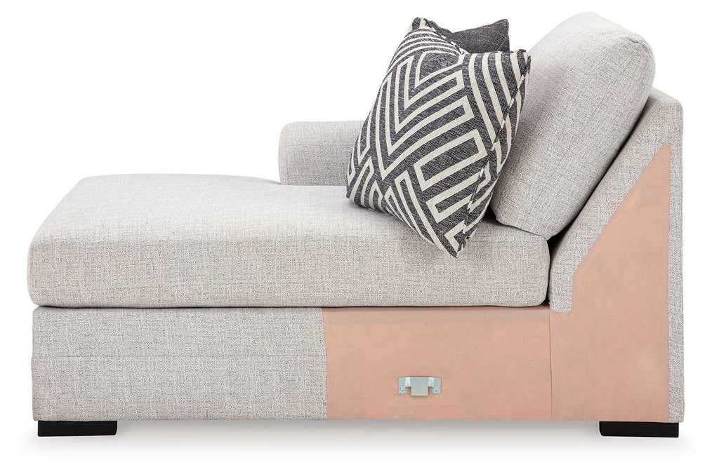 Stone gray chaise corner seat with patterned lumbar pillow and wood-tone base panel