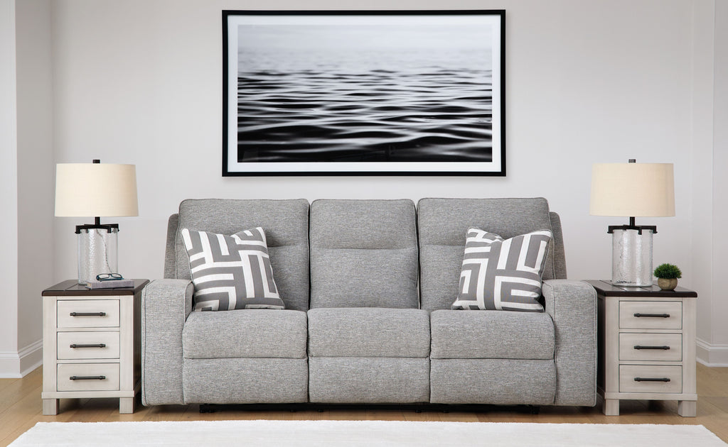 Pewter power reclining sofa with three seat sections, gray upholstery, and patterned throw pillows