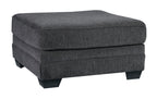 Dark gray ottoman with rectangular cushioned top and upholstered base