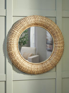 Round woven rattan accent mirror with arched frame, reflecting room