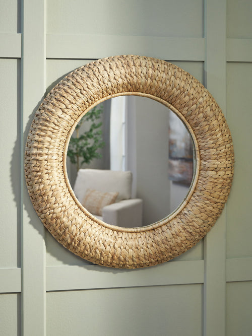 Round woven rattan accent mirror with arched frame, reflecting room