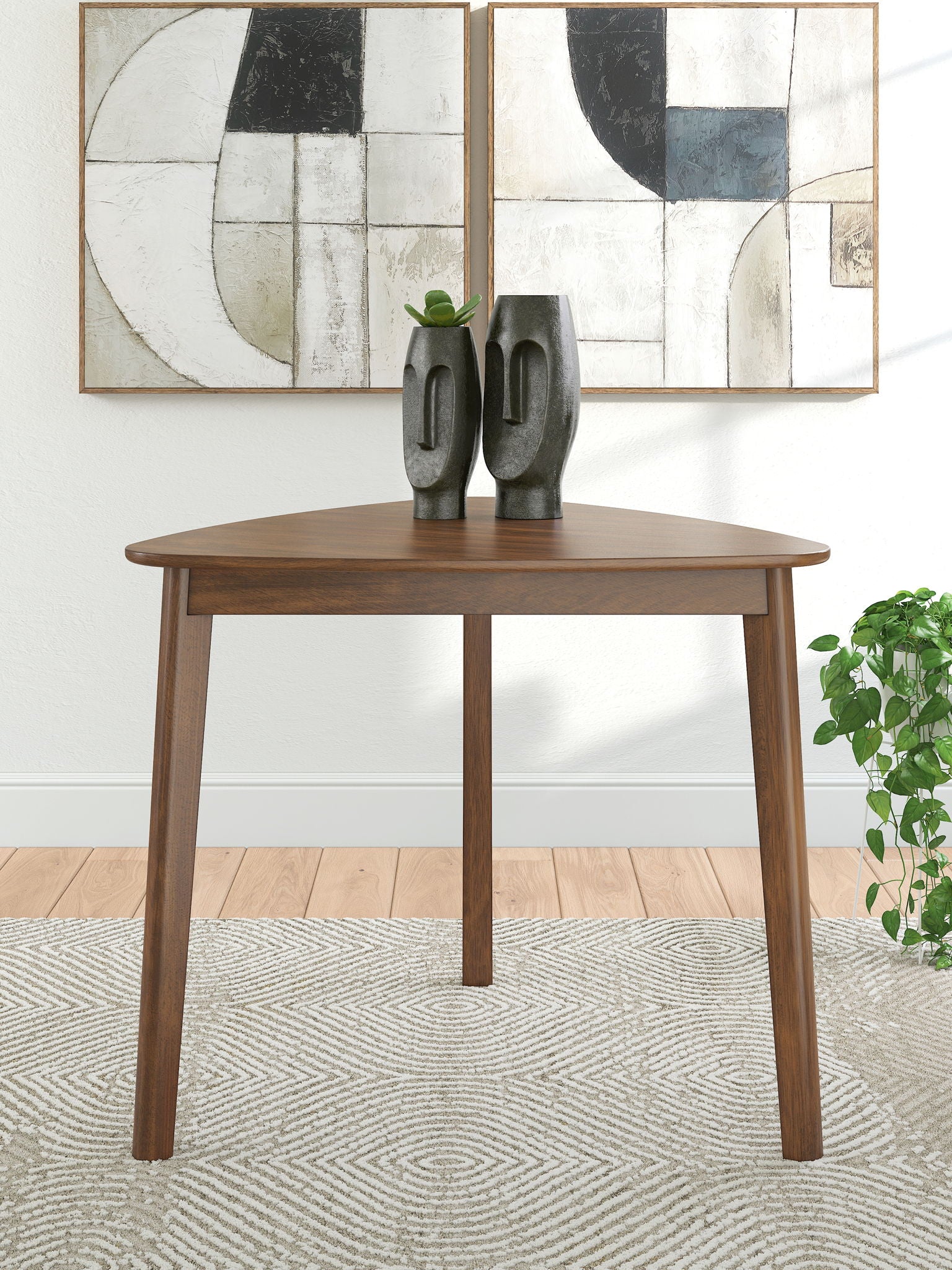 Brown triangle dining table with a smooth round top and straight legs