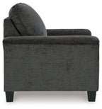 Dark gray upholstered armchair side view with wide armrests and tapered legs
