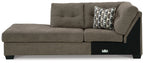 Brown left-arm corner chaise with tufted back, patterned pillow, and black legs