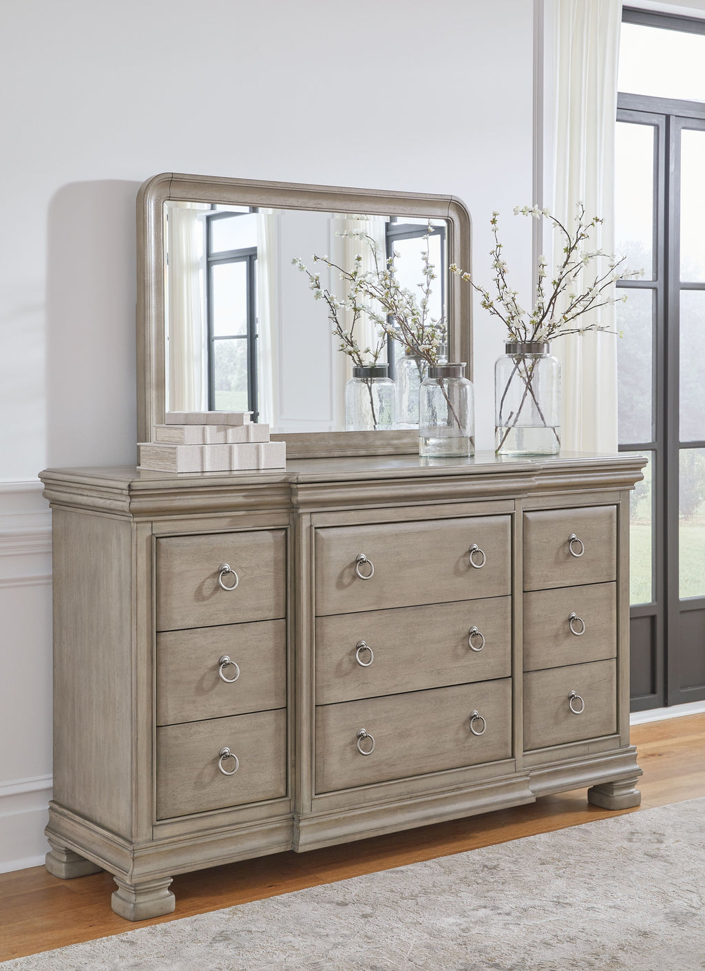 Gray dresser and wall mirror with multiple drawers and oval pulls