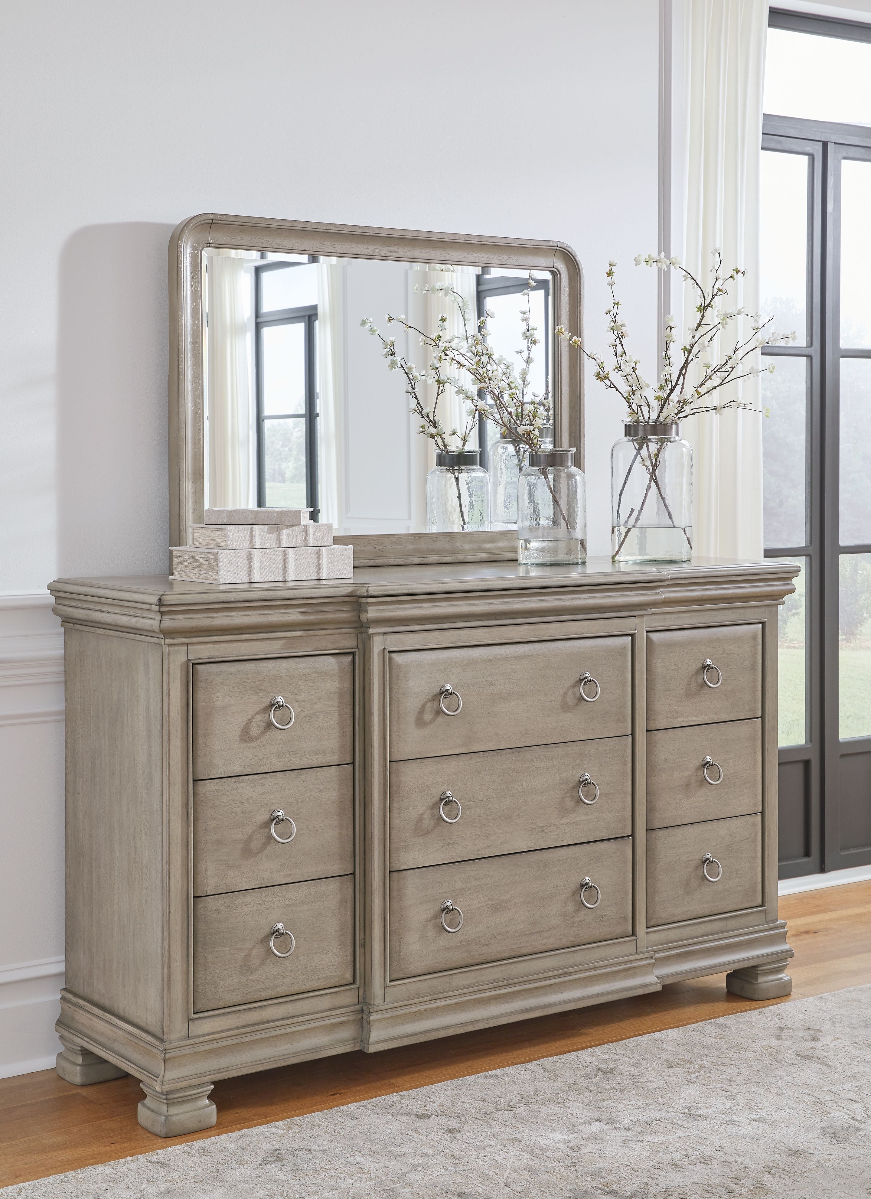 Gray dresser and wall mirror with multiple drawers and oval pulls