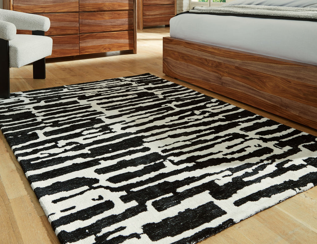 Black-and-white abstract striped area rug with irregular blocks