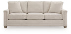 Light beige fabric sofa with four back cushions, three seat cushions, short legs