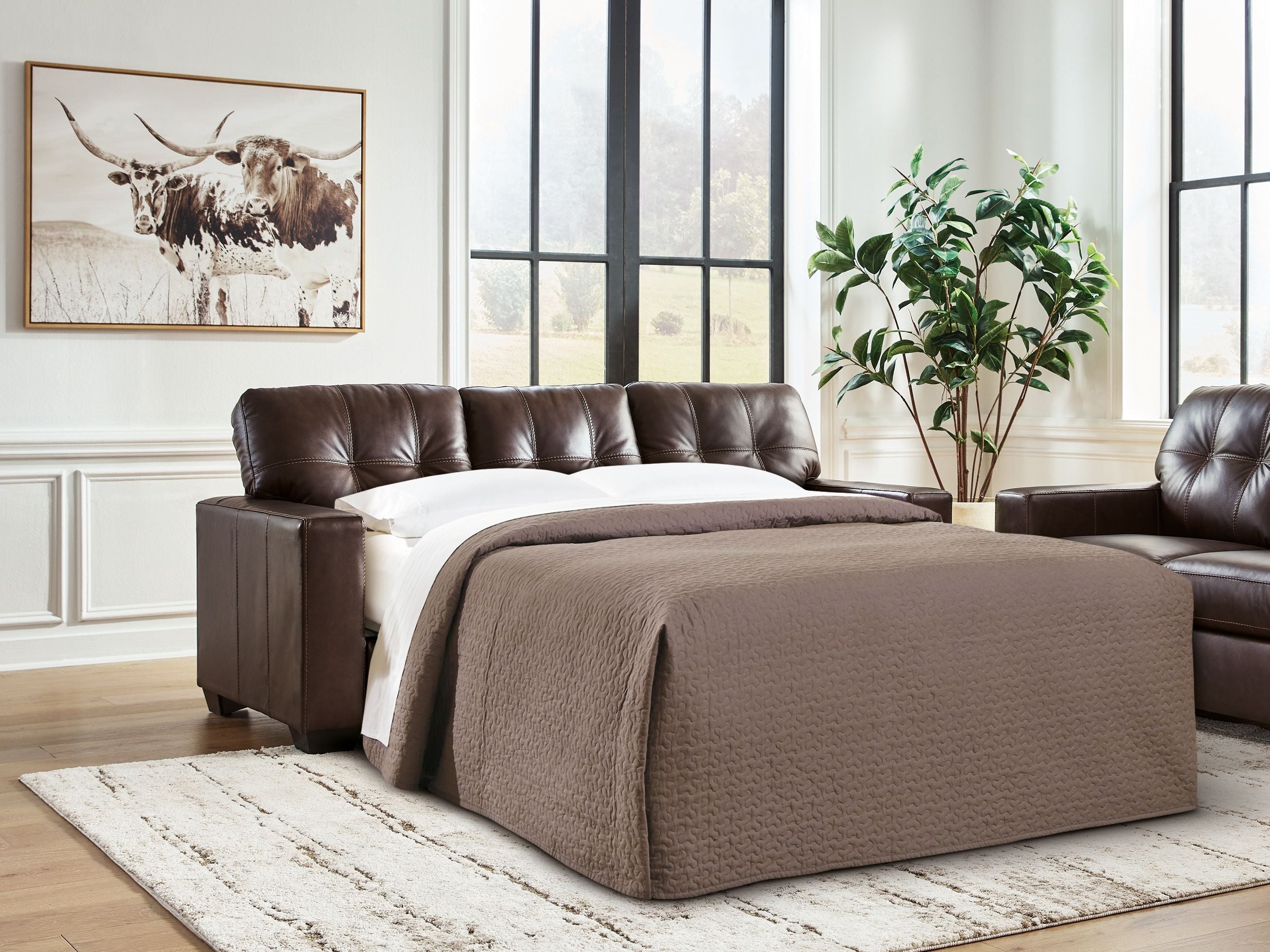 Dark brown sofa sleeper with mattress extended for sleeping