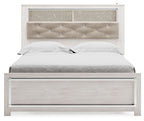 Queen bookcase bed with white slatted sides and padded light beige tufted headboard
