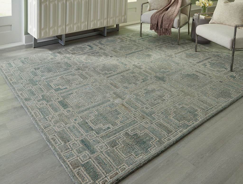 Green geometric area rug with repeating square motifs, flat-woven look