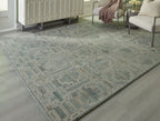 Green geometric area rug with repeating square motifs, flat-woven look