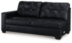 Dark two-seat sofa with tufted back cushions and wide armrests