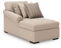 Beige corner chaise with black legs and three throw pillows, striped and patterned