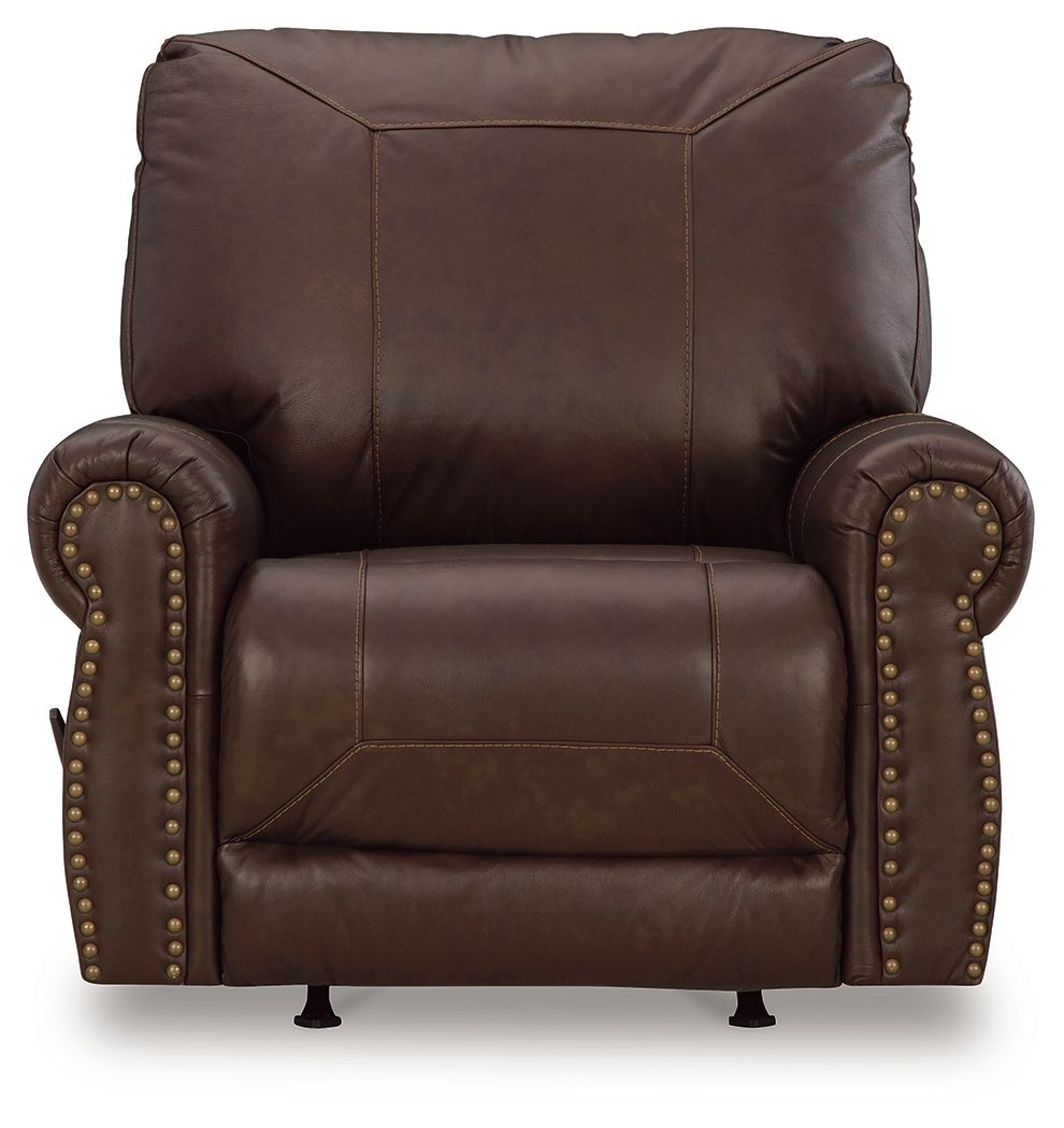 Dark brown leather-look rocker recliner with tall back, studded sides, padded seat