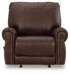 Dark brown leather-look rocker recliner with tall back, studded sides, padded seat