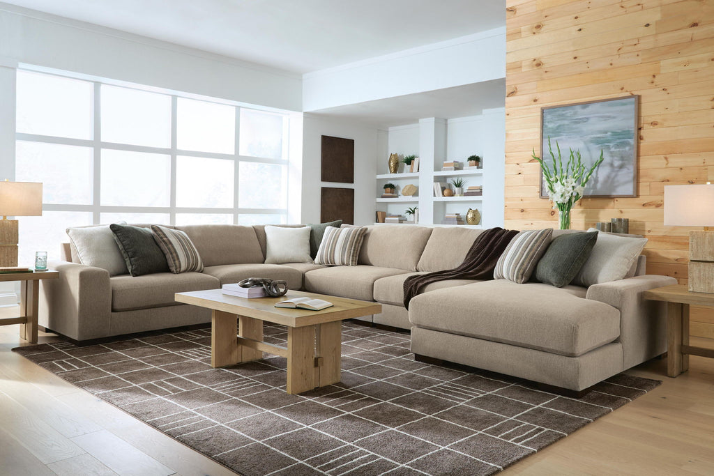 Light brown sectional sofa with chaise corner and striped throw pillows
