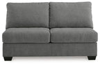 Gray armless loveseat with two back pillows and a boxy two-seat base