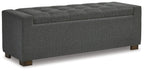 Gray upholstered storage bench with tufted top and dark wooden legs