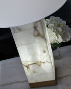 Alabaster-style lamp base with white veining, gold trim, and white drum shade