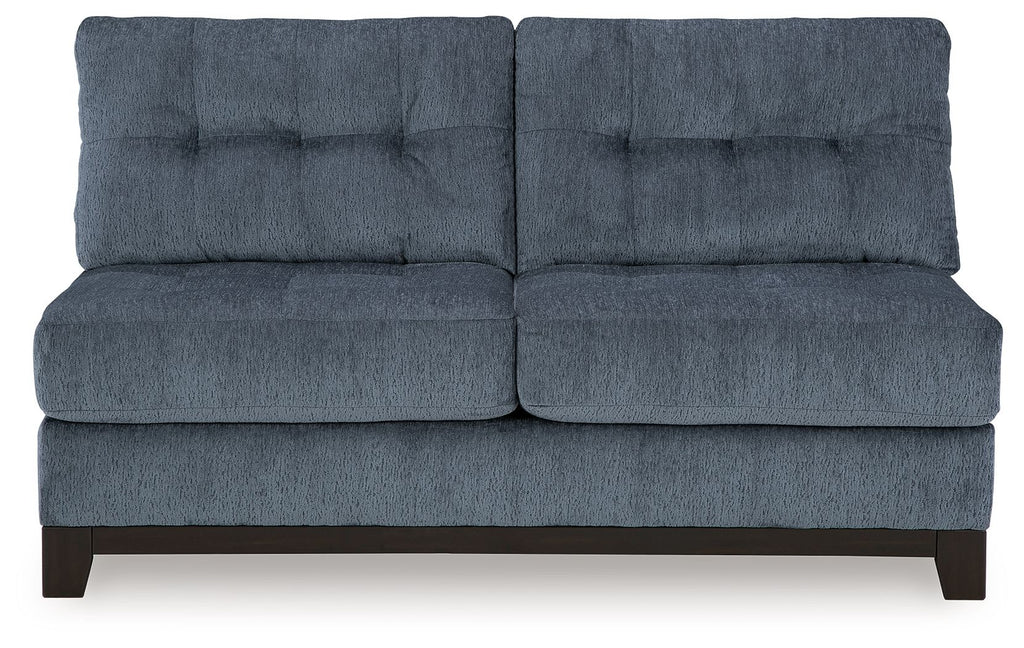 Navy armless loveseat with tufted back, cushioned seat, and dark wooden feet