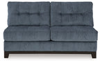Navy armless loveseat with tufted back, cushioned seat, and dark wooden feet