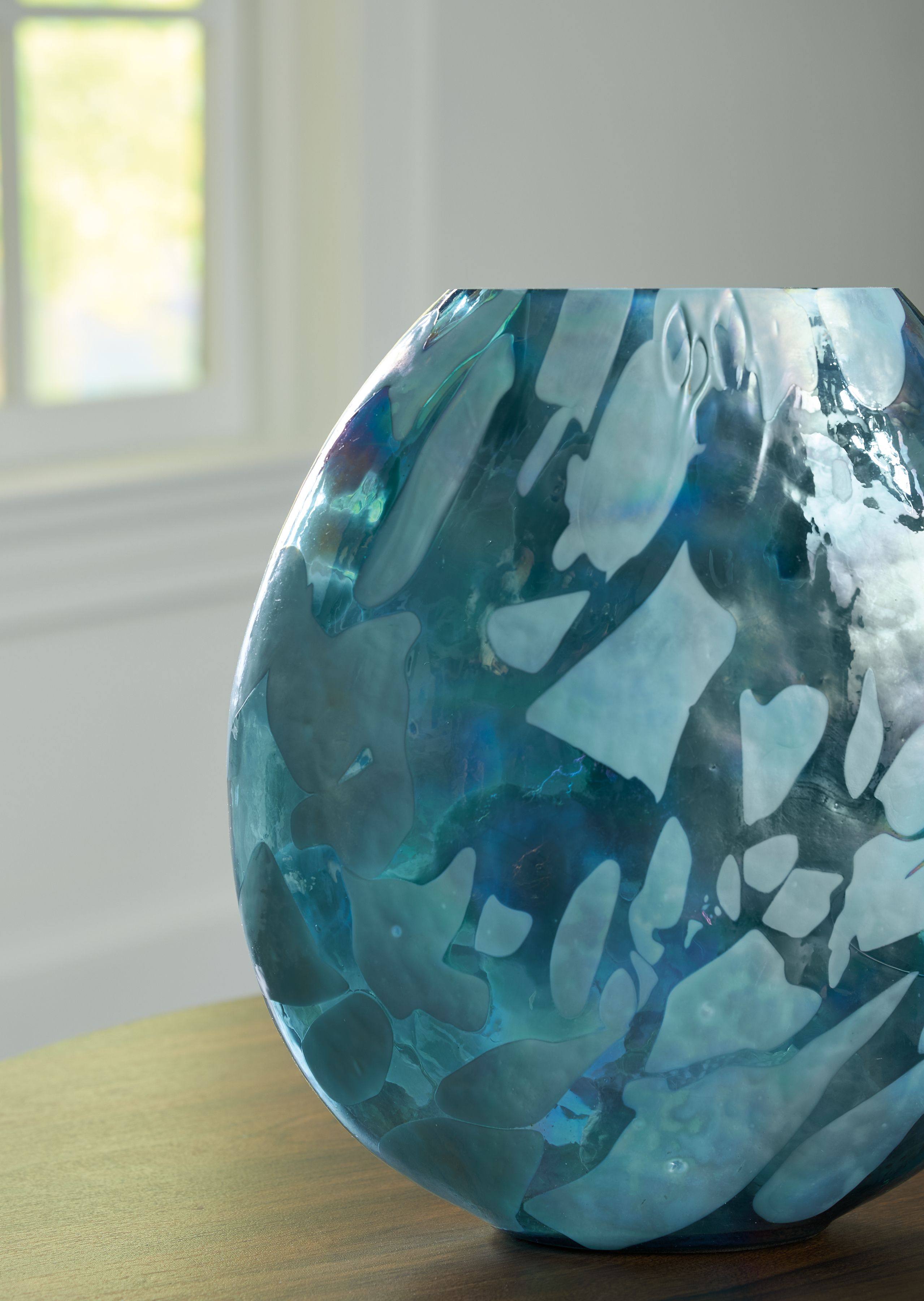 Blue glass vase with flared top and curved sides, abstract mottled finish