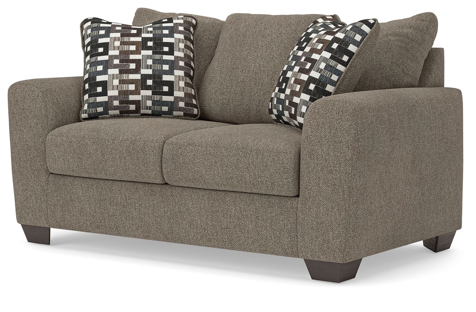 Grey suede loveseat with padded arms and two patterned throw pillows