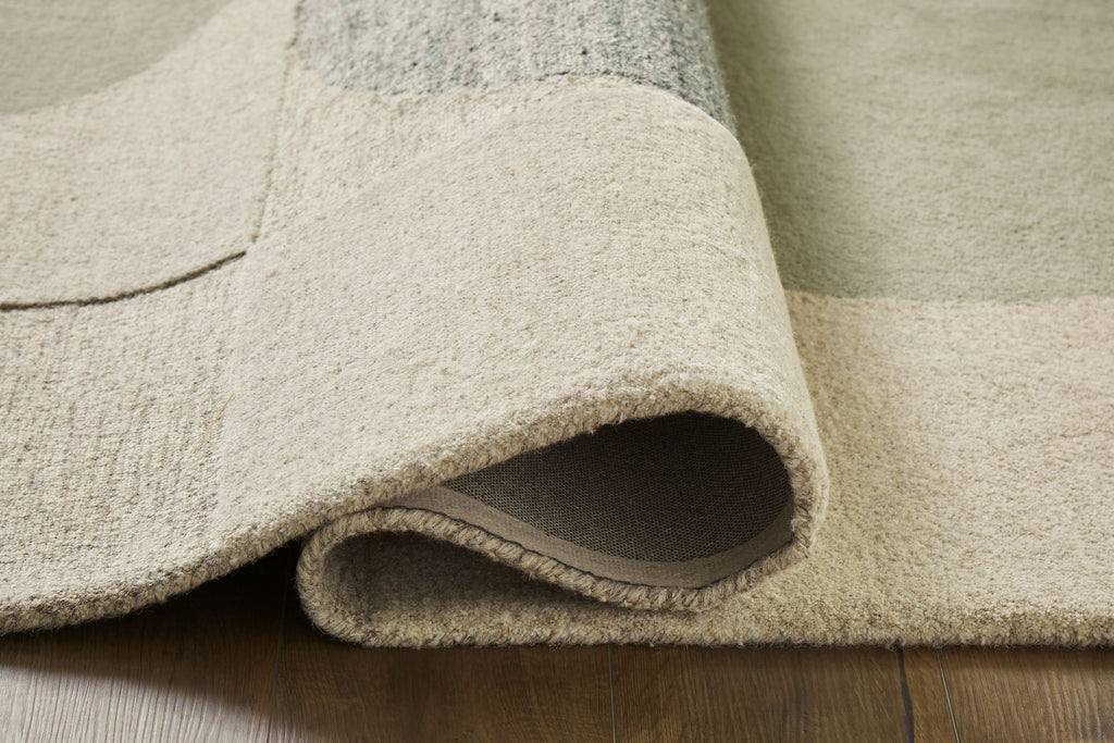 Beige rug pile with rolled edge and textured underside