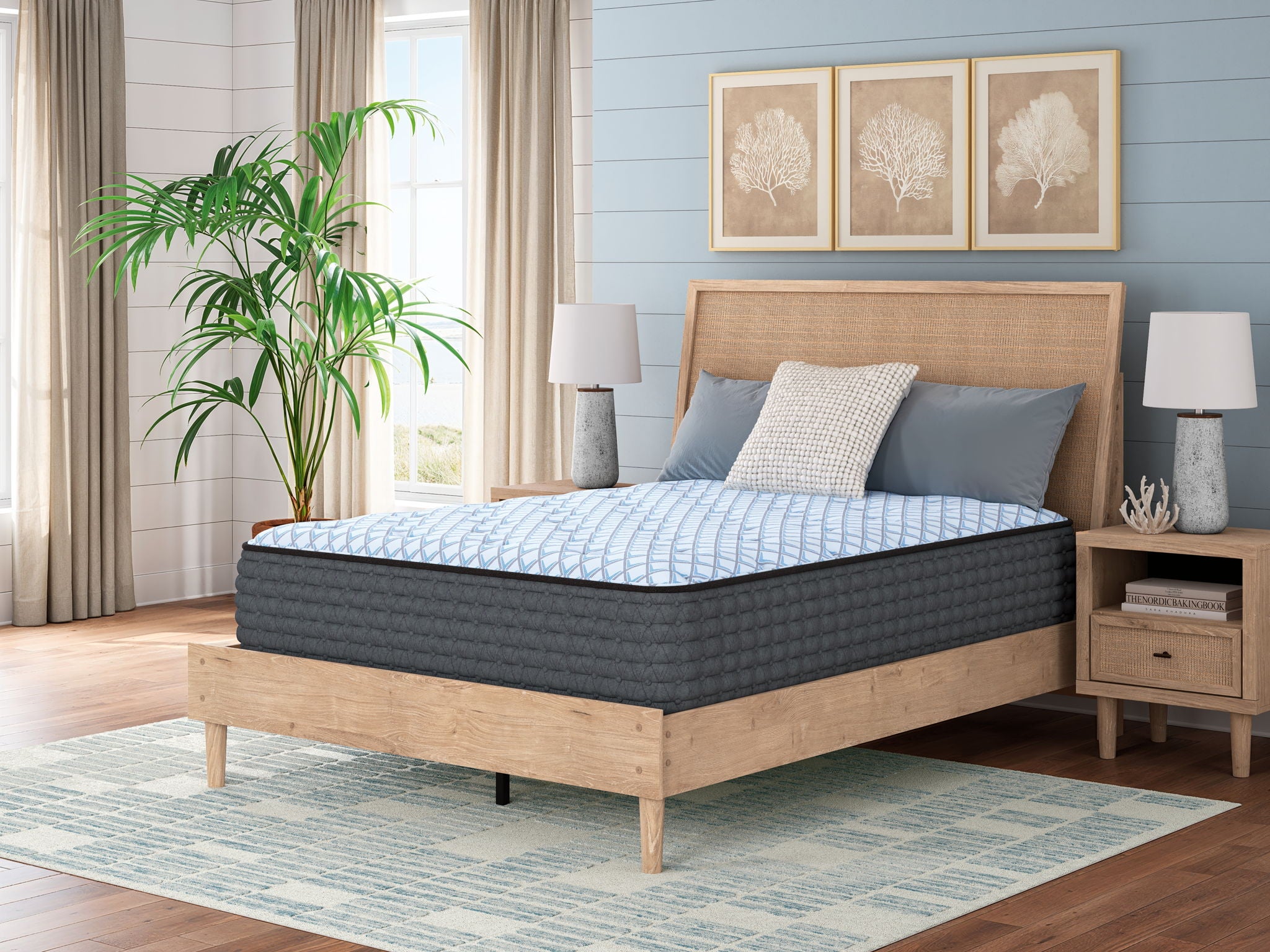 Blue plush mattress on bed frame with pillows, textured quilted top