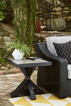 Outdoor black square end table with X-style base near seating