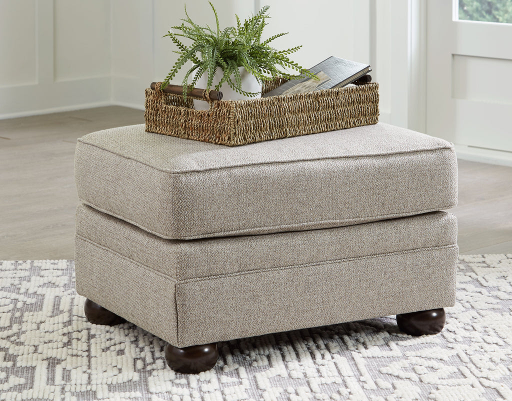 Square light beige ottoman with padded top and dark wooden legs