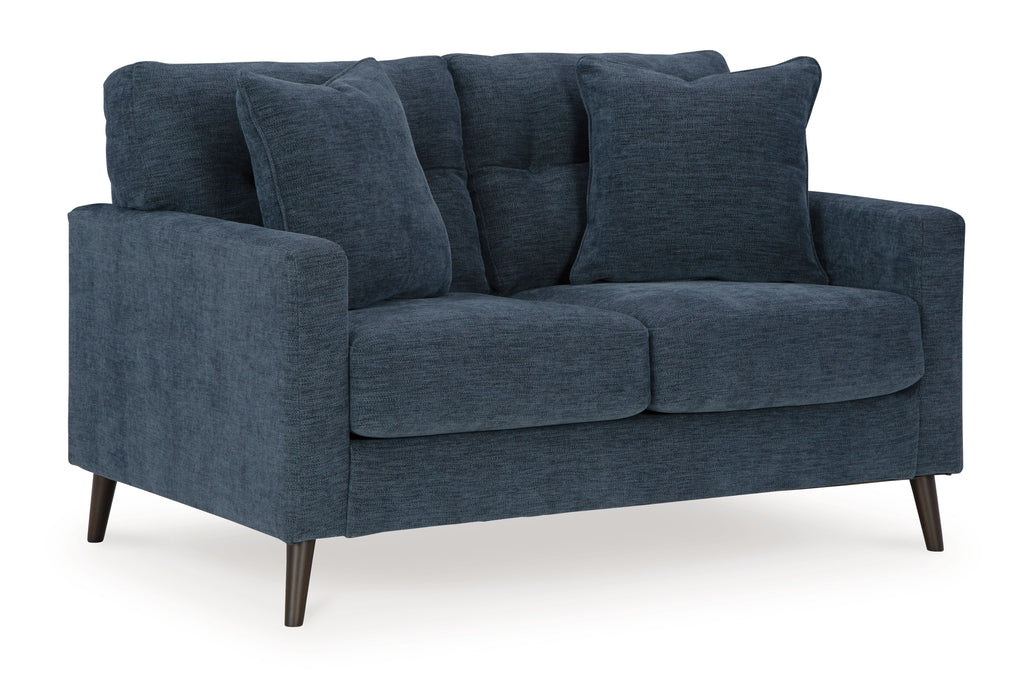 Blue loveseat with tufted back, rolled arms, and two cushioned seat sections.