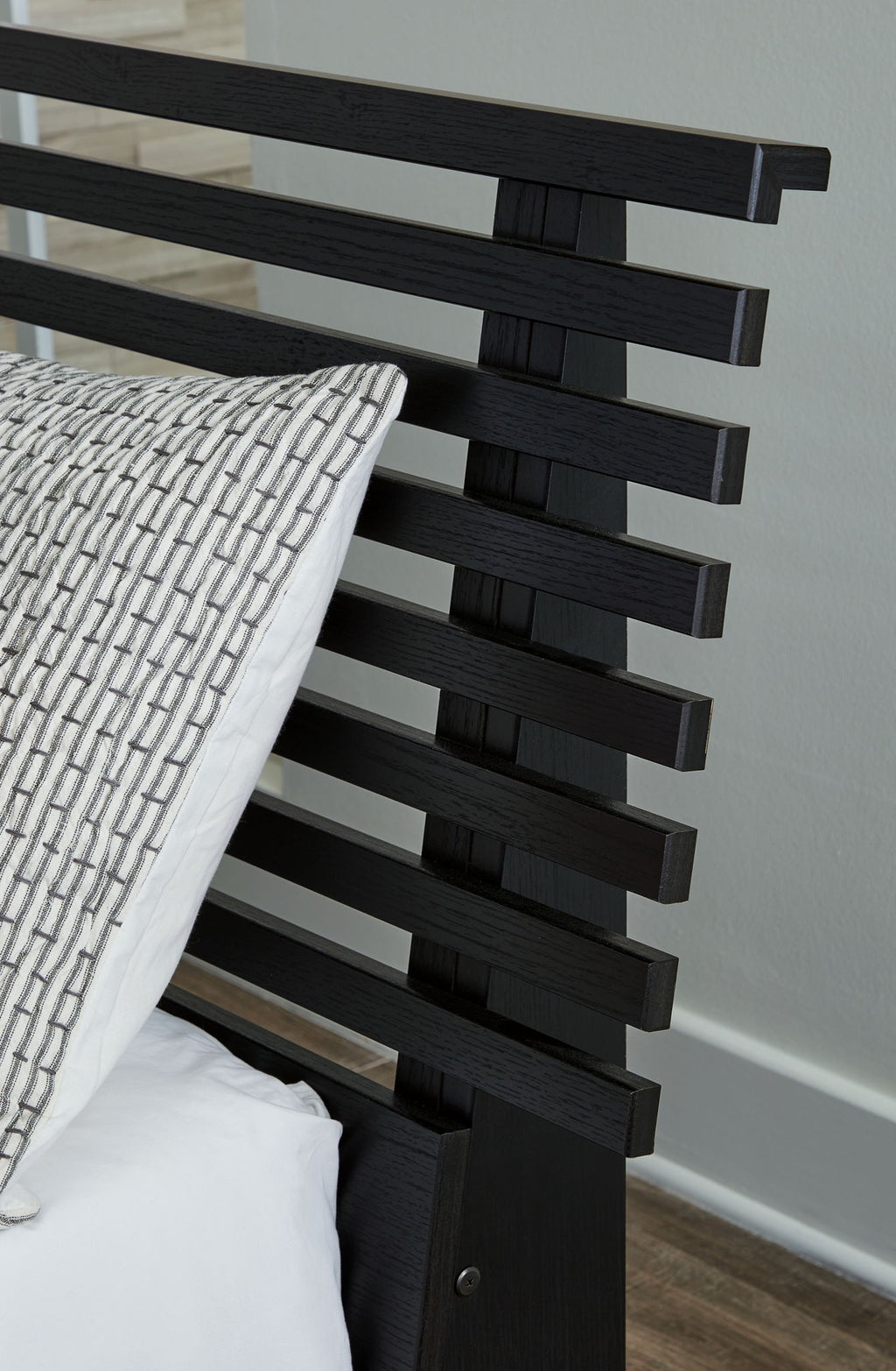 Black slat headboard side view with stacked horizontal bars and post ends