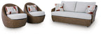 Outdoor set of swivel chairs and loveseat with beige wicker and white seat cushions