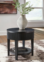Black round end table with ribbed skirt, round top, and storage shelf