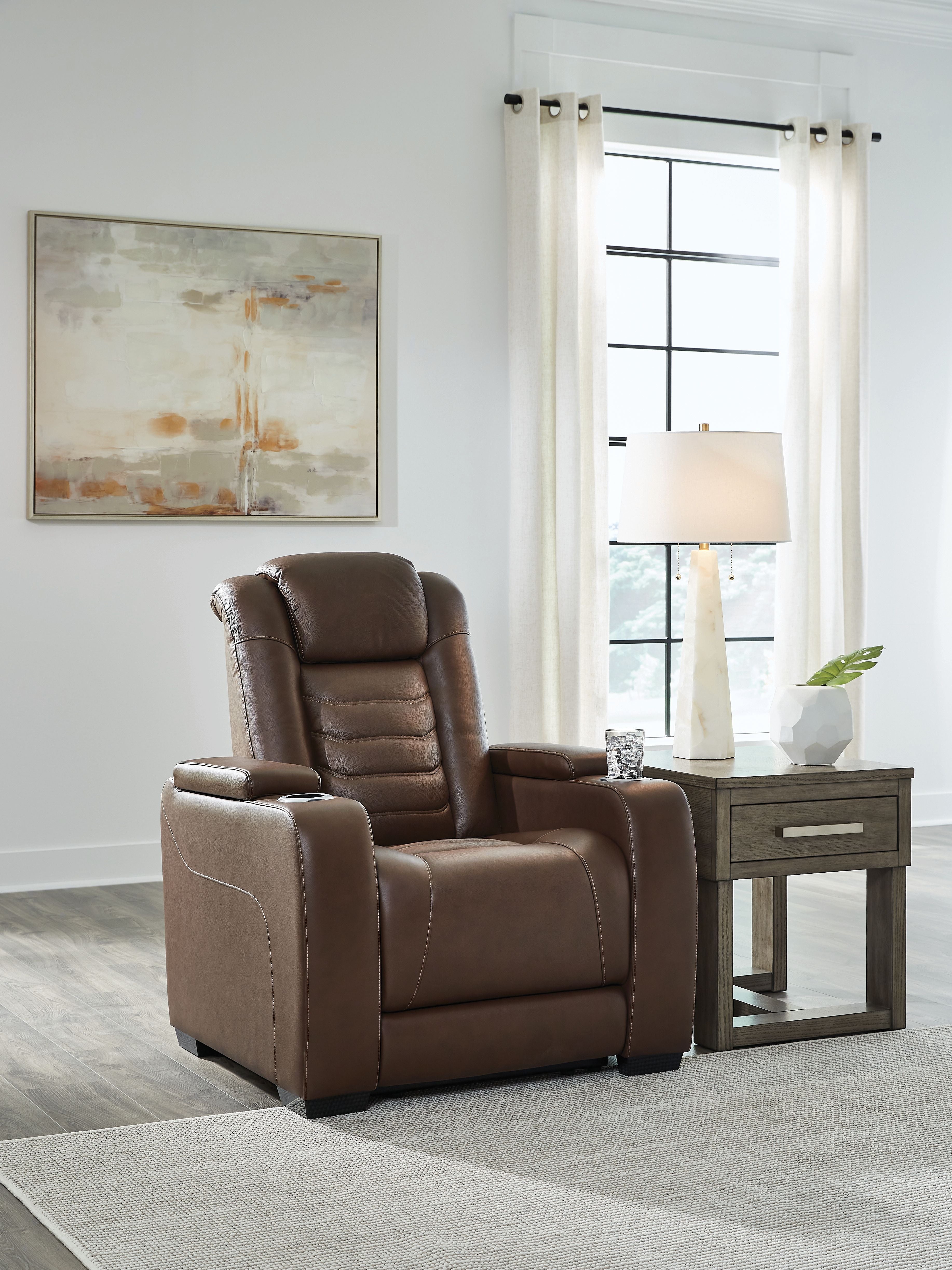 Brown power recliner chair with adjustable headrest and wide padded arms