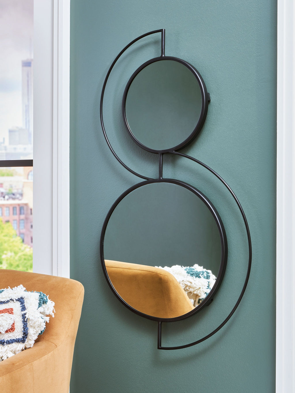 Black accent mirror set of two circular frames with reflective glass, mounted on wall