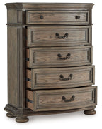 Light brown five-drawer chest with side panel details and black metal drawer pulls