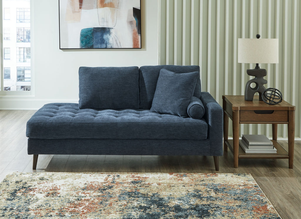 Blue corner chaise sofa with two back cushions and dark tapered legs