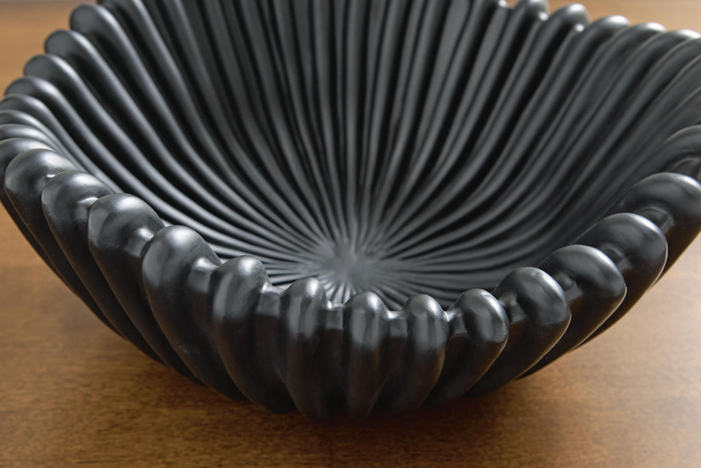 Black ribbed bowl with stacked scallops, close-up interior