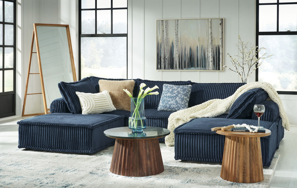Navy modular sectional sofa with ribbed upholstery and multiple toss pillows