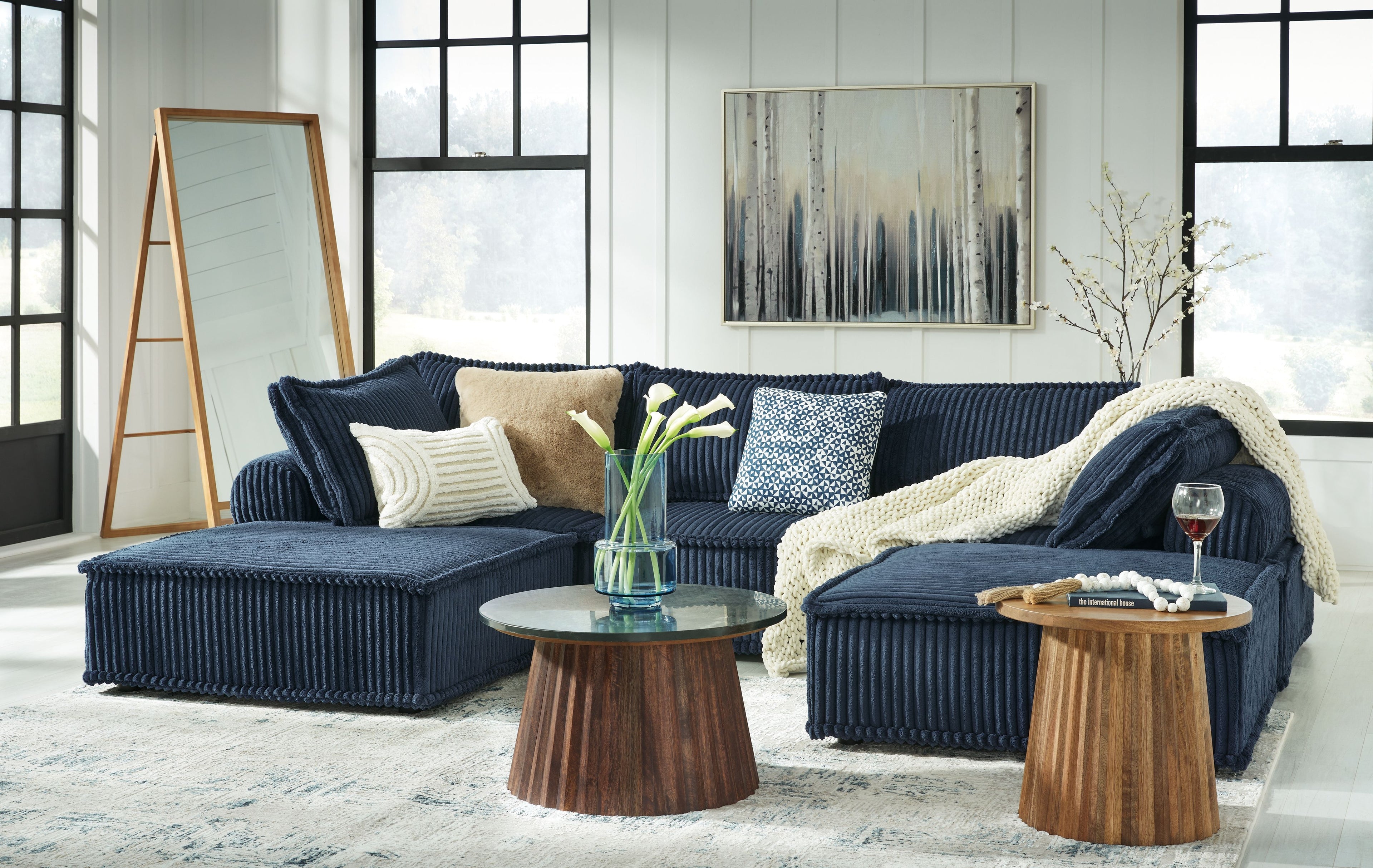 Navy modular sectional sofa with ribbed upholstery and multiple toss pillows