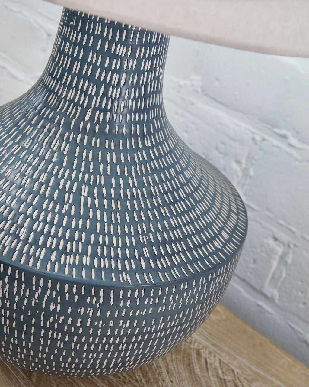 Textured metal table lamp base with narrow neck and dotted linear pattern